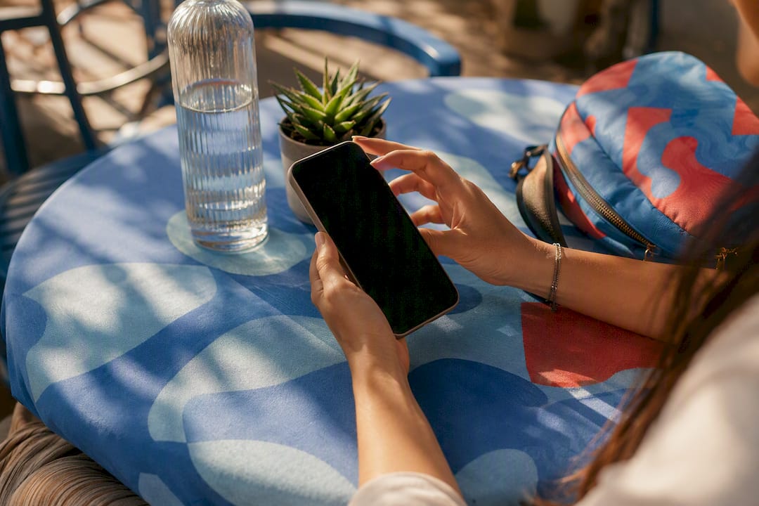 Close-up hand holding smartphone with social media engagement focus