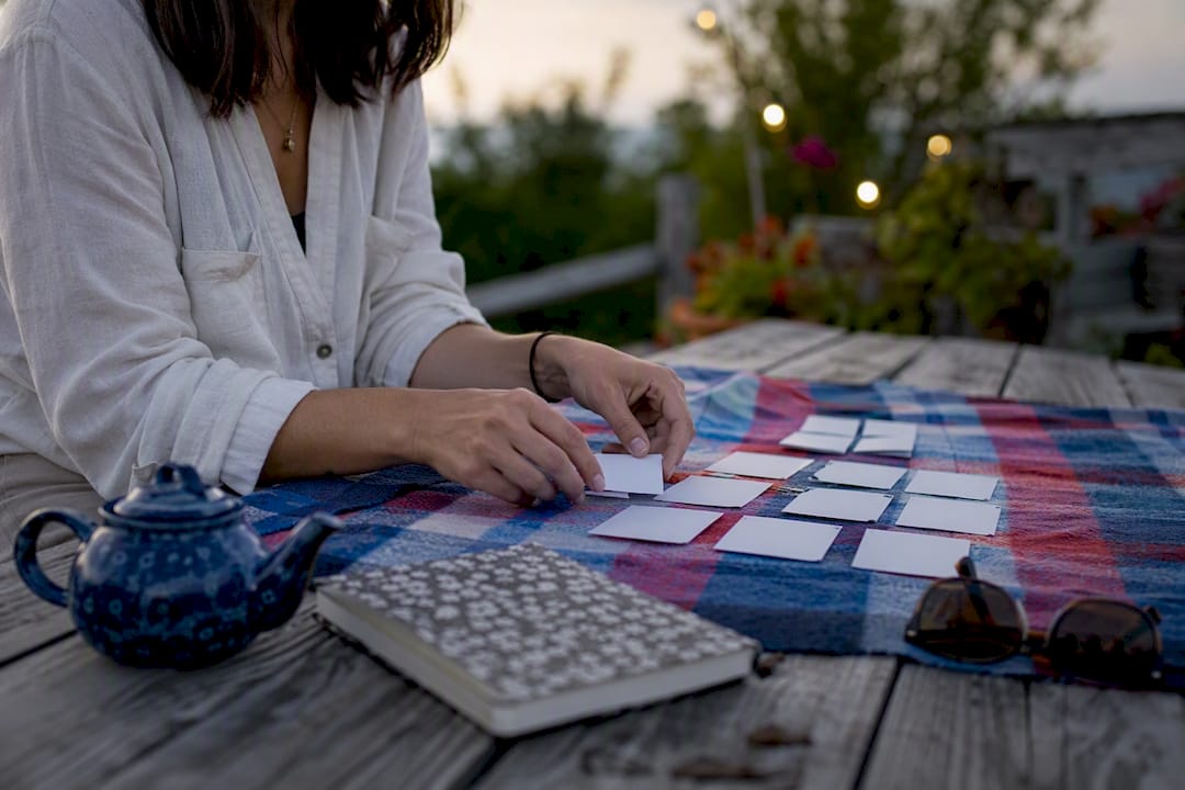 Hands arranging storyboard cards on desk