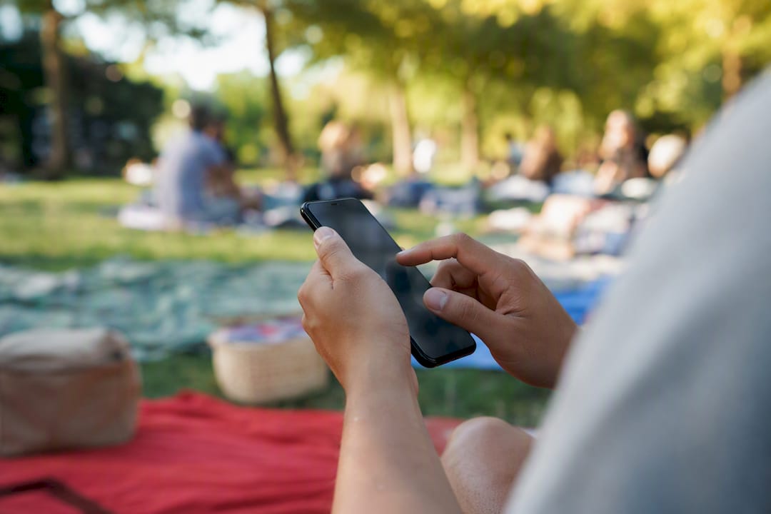 Hands holding smartphone coordinating engagement pods